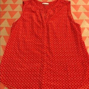 Red sleeveless top with white cross cross pattern